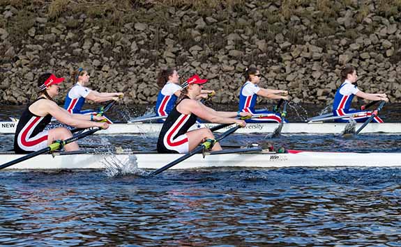 Two boats taking part in a rowing race.